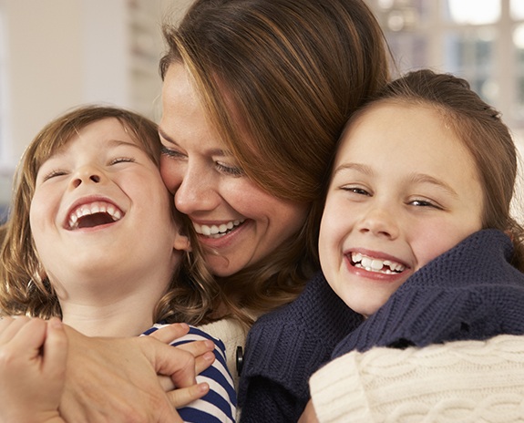 Mother and two children laughing together