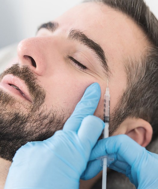person receiving BOTOX injections to get rid of crow’s feet lines