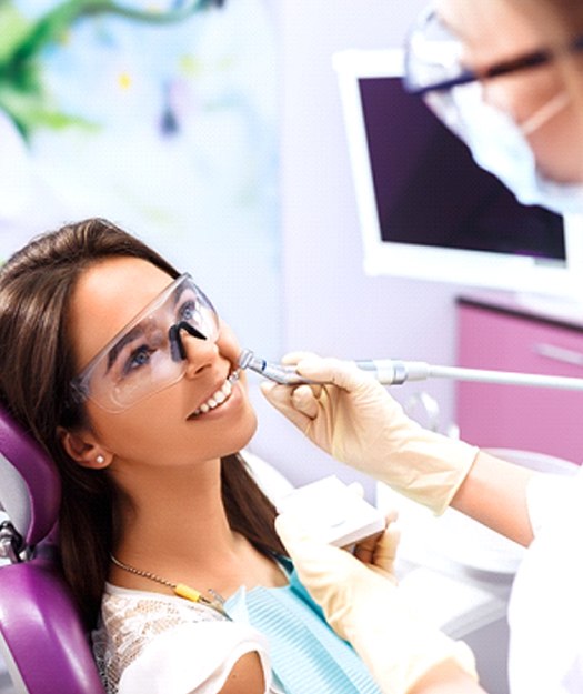 A young woman undergoes a dental checkup and cleaning during a regular appointment in Pewaukee