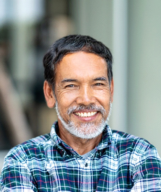 Man smiling while wearing dentures in Pewaukee