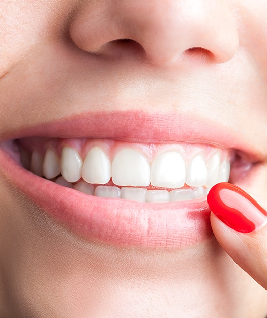 Patient pointing to smile after scaling and root planing treatment