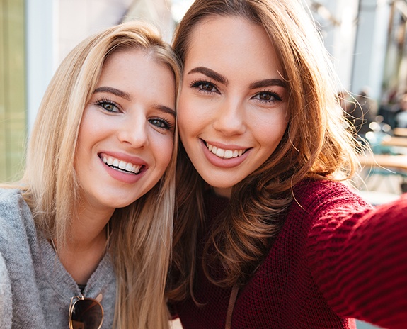 Two women smiling together after Botox filler treatments