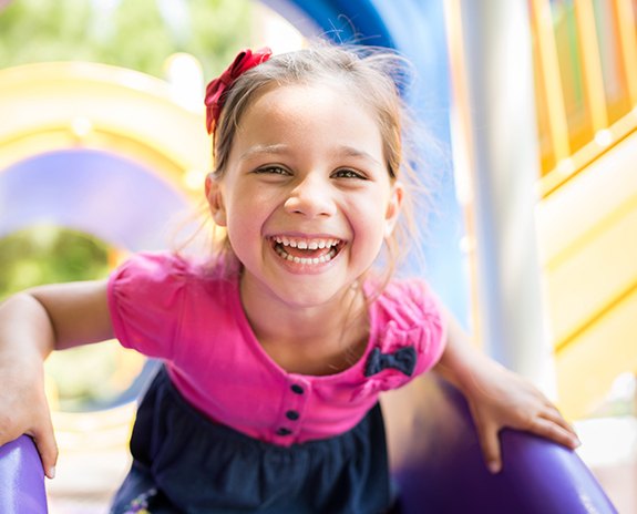 Little girl smiling after children's dentistry treatment