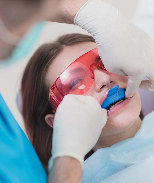 Young woman receiving fluoride treatment