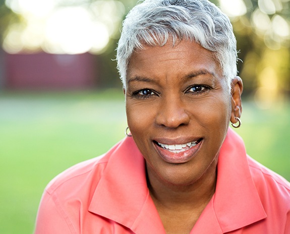 Woman sharing smile after replacing missing teeth