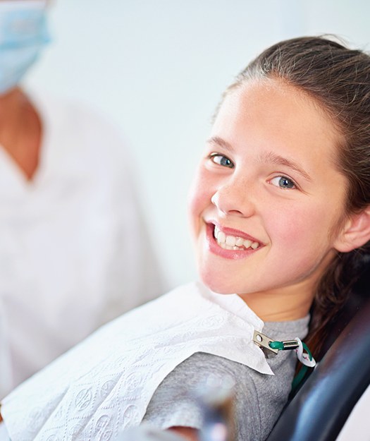 Young girl smiling after fluoride treatment