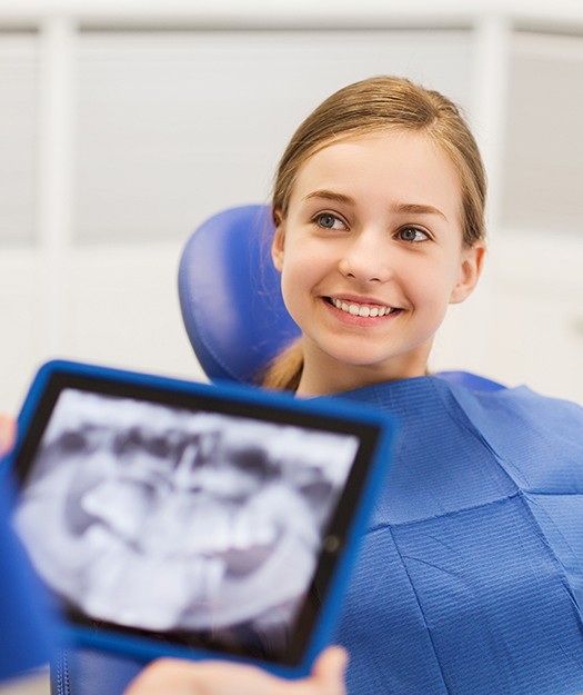 Preteen girl smiling during orthodontic screening