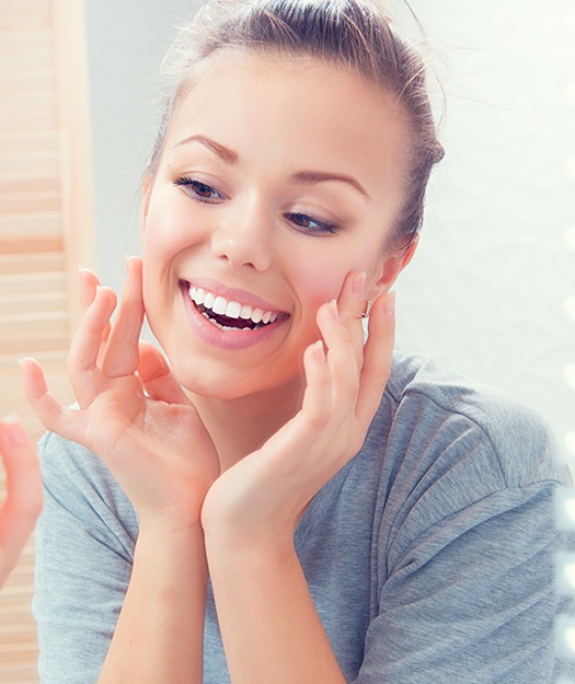 Woman looking at smooth skin after Botox treatment