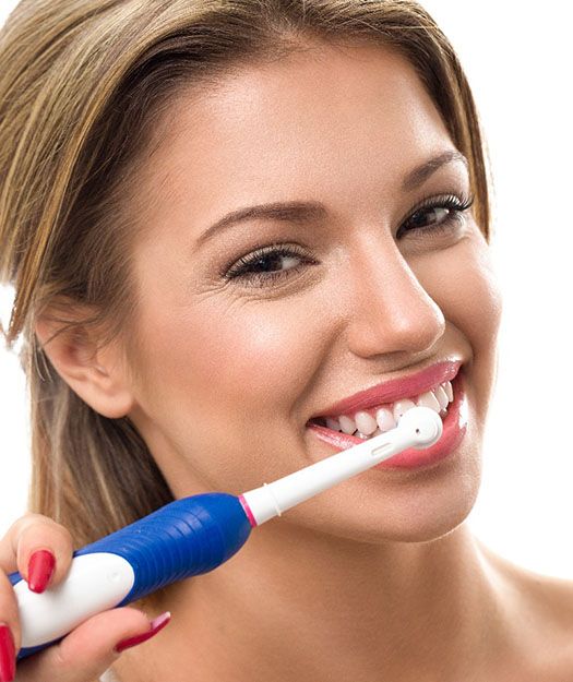 Young woman with dental implants in Pewaukee brushing her teeth