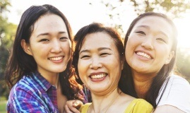 Three women sharing healthy smiles after checkup