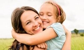 Mother hugging daughter after children's visit