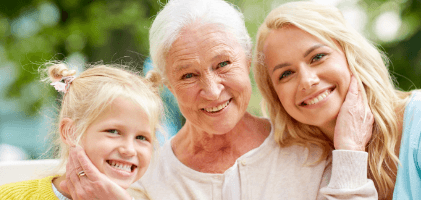Three generations of women sharing healthy smiles thanks to preventive dentistry